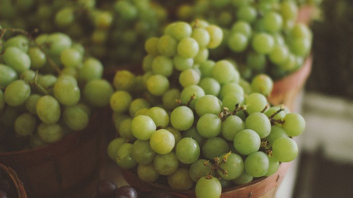 Close-up of green grapes in baskets