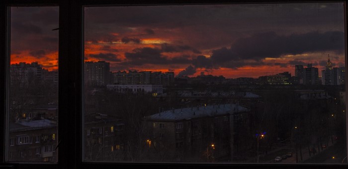 Cityscape at sunset with orange clouds