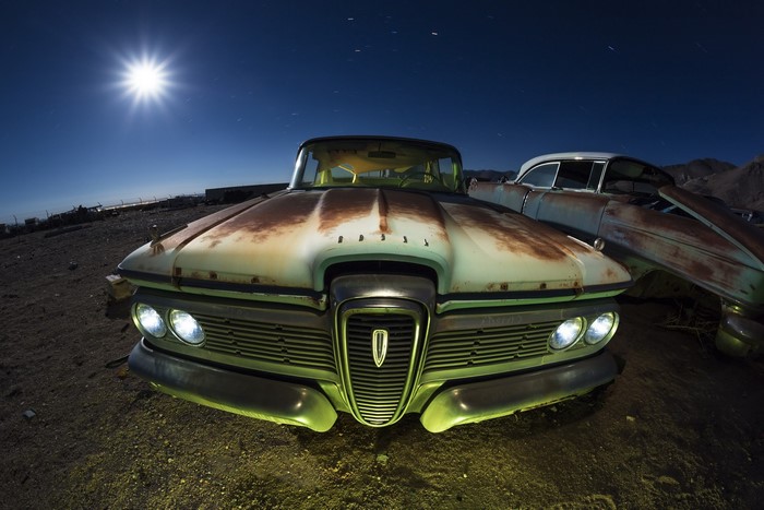 Abandoned Ford Edsel and other cars at night