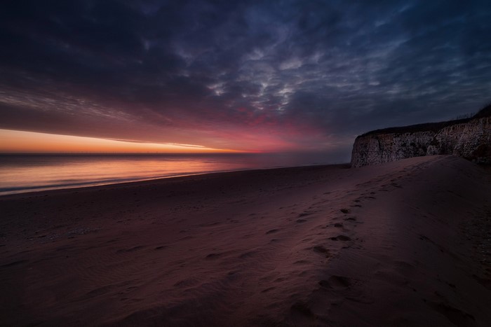 Beach cliff at dusk with colorful sky