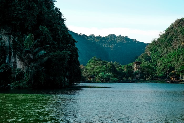 Lake surrounded by lush green mountains and trees