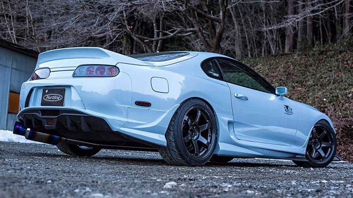 White Toyota Supra with custom body kit and exhaust