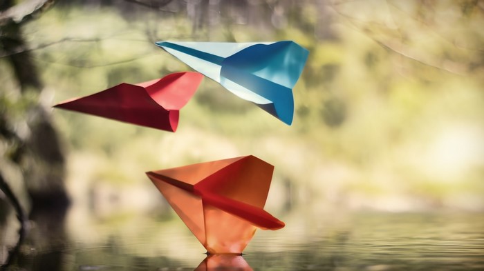 Paper airplanes floating on water