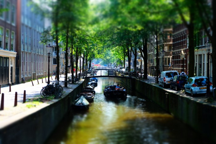 Amsterdam canal with boats and trees