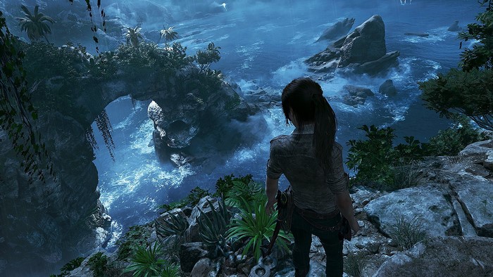 Lara Croft overlooking a rocky coastline in Shadow of the Tomb Raider