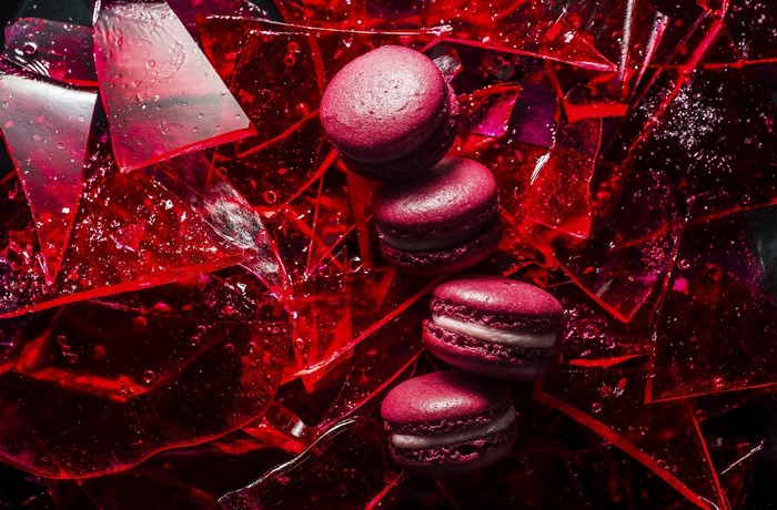 Red macarons on broken red glass shards