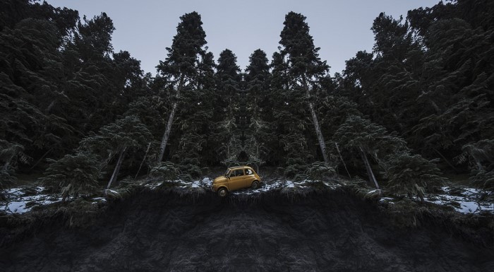 Yellow Fiat 500 in a dark forest