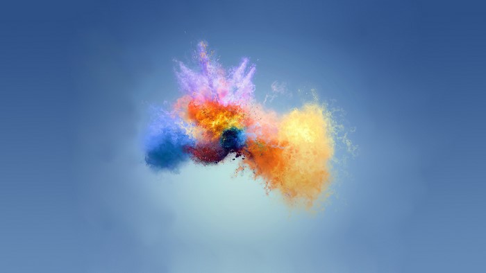 Colorful powder explosion on blue background