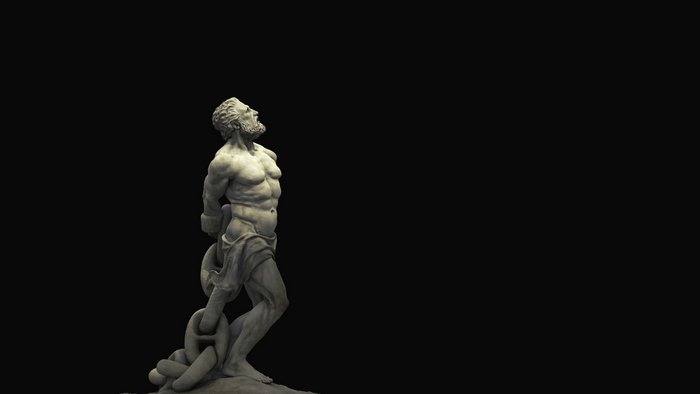 Statue of a chained man looking up