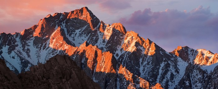 Mountain range at sunrise with snow and rocks