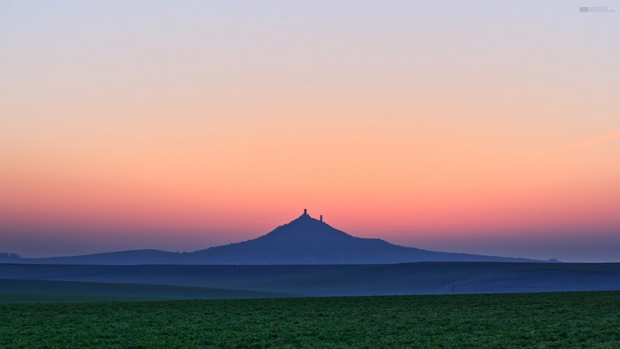 Castle silhouette on a hill at sunset in Czech Republic