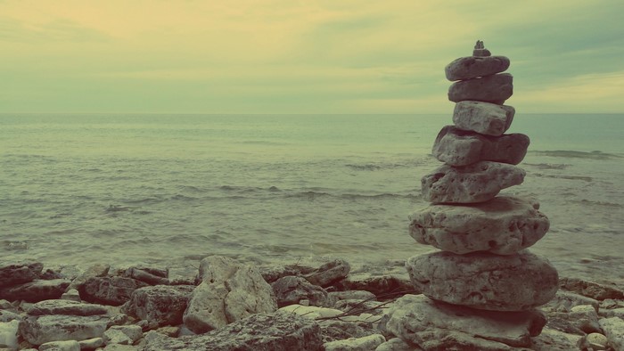 Stacked stones on a rocky shore by the sea