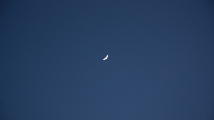 Crescent moon in a dark blue sky