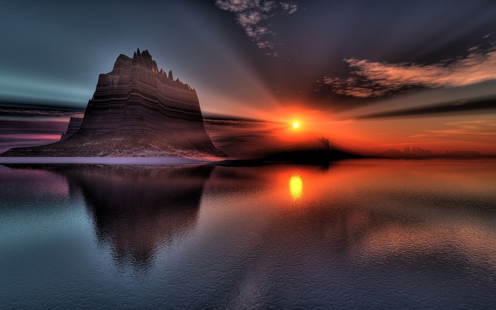Mountain reflection at sunset over water