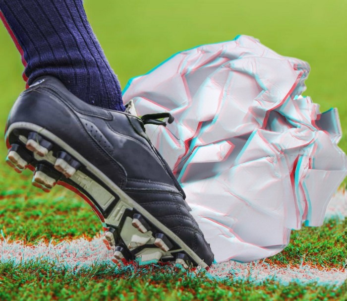 Soccer shoe kicking crumpled paper ball