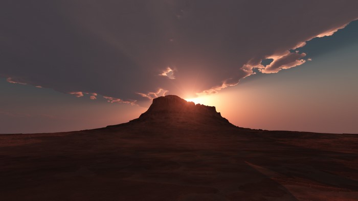 Sunset over a desert mountain landscape