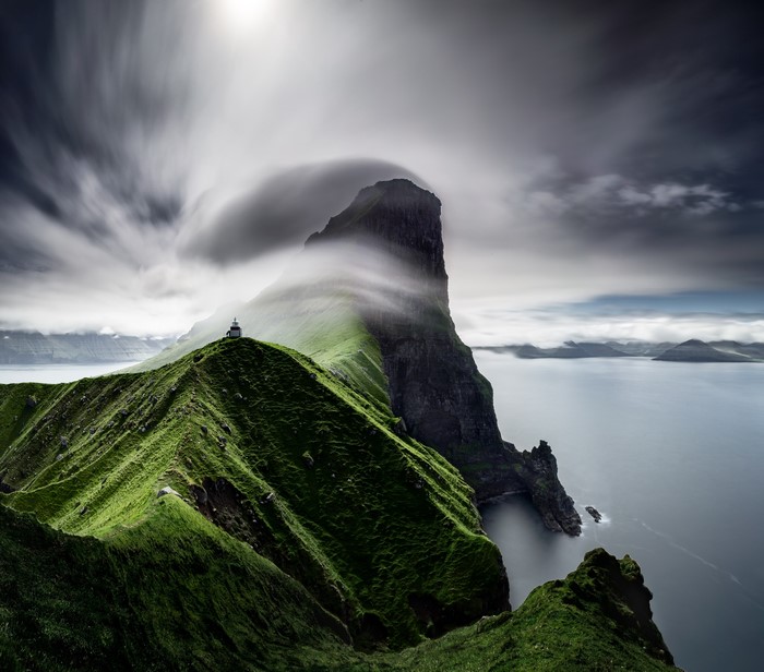 4K Lighthouse on a Grassy Cliff Overlooking the Ocean