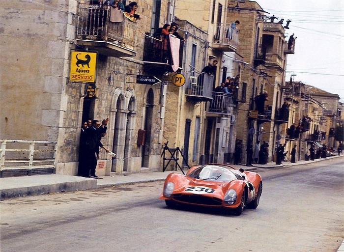 Red Ferrari 330 P4 race car with number 230 on a street