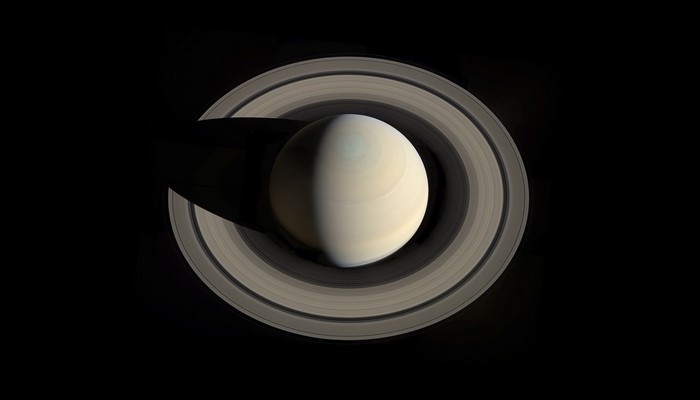 Saturn and its rings in space