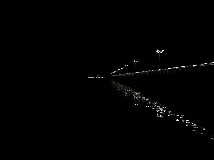 Street lights reflecting on water at night