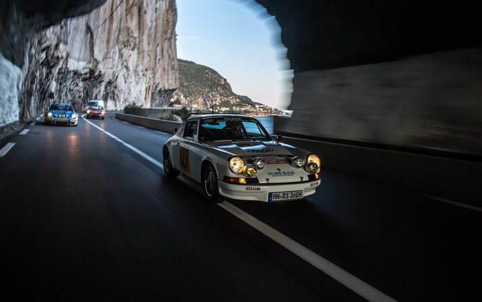 Porsche 911 rally car driving through a tunnel