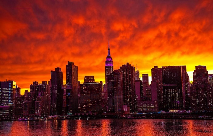 Manhattan Skyline at Dusk with Vibrant Orange Sky