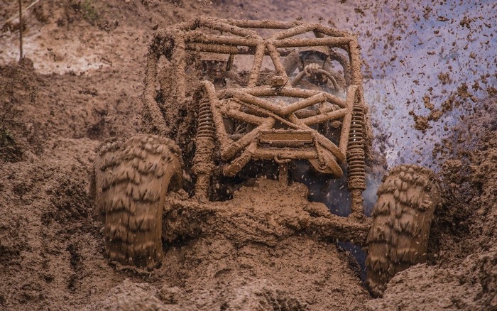 Off-road vehicle driving through mud
