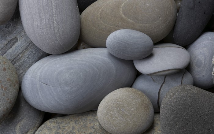 Close-up of smooth, rounded stones with varied textures and colors