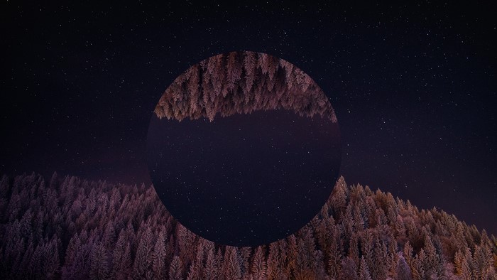 Abstract circle over snowy forest and starry night sky