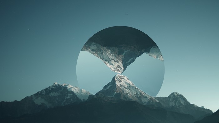 Snow-capped mountains reflected in a circular portal