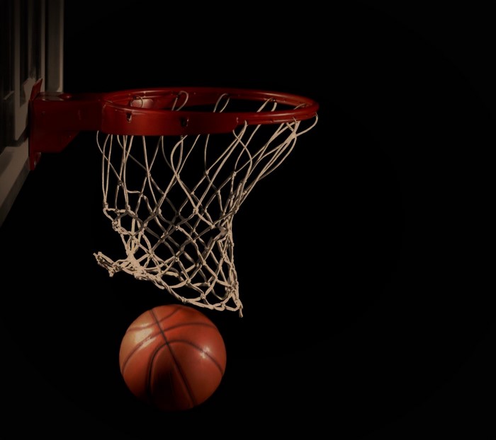 Basketball and hoop against a black background