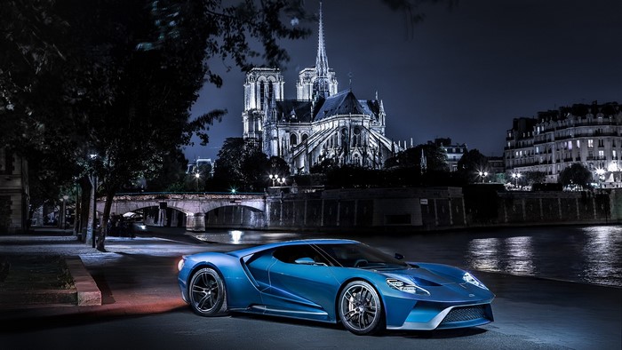 Blue Ford GT Mk II parked at night in front of Notre Dame Cathedral, Paris