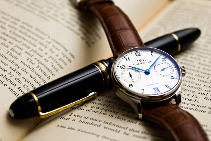 IWC Schaffhausen watch and fountain pen on a book