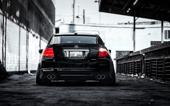 Black Acura TL rear view in urban alley