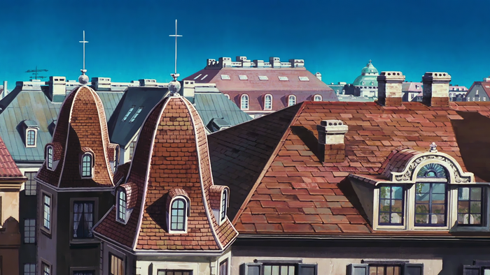 Rooftops of a European-style city under a blue sky