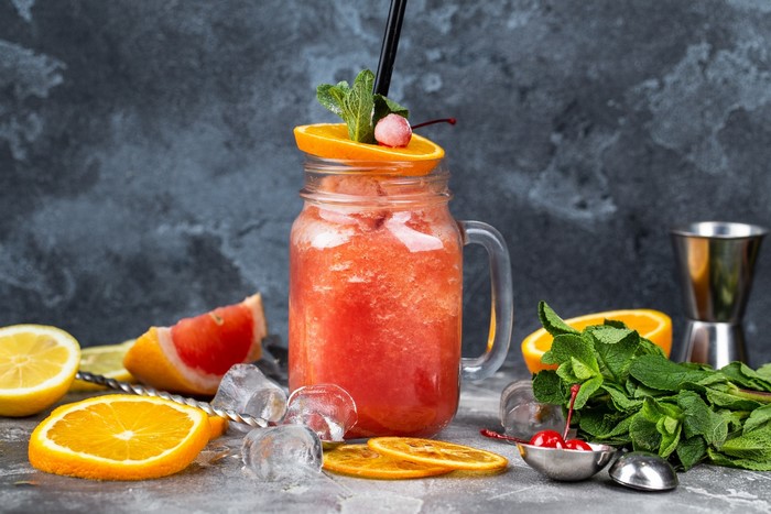 Fruity cocktail with orange, mint, and cherries