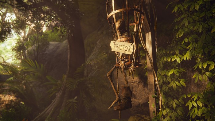 Skeleton in a cage labeled "TRAITOR" in a jungle