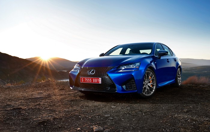 Blue Lexus GS F on a hill at sunset
