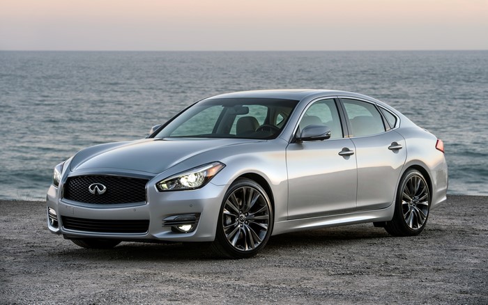Silver Infiniti sedan parked by the ocean