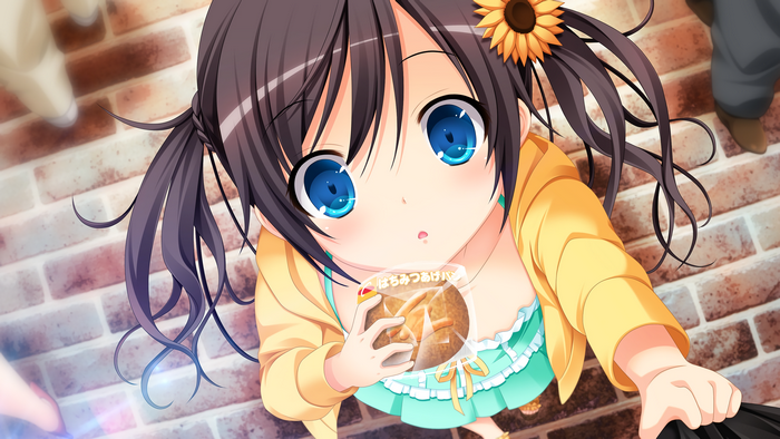 Girl with pigtails holding a snack
