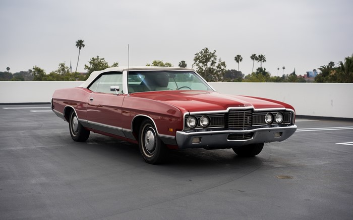 Red convertible car on a rooftop parking lot