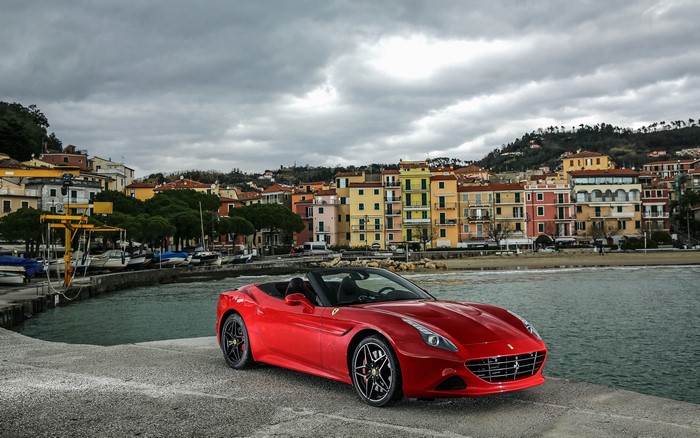 Red Ferrari California convertible by the sea