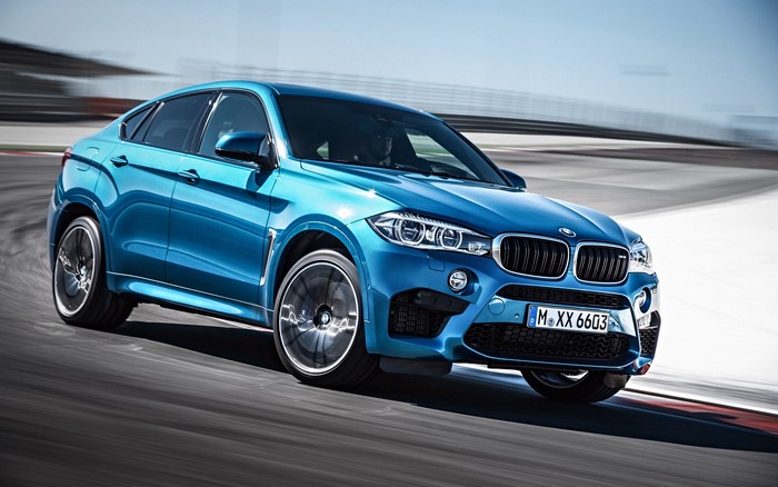 Blue BMW X6 M on a Race Track