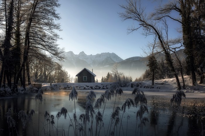 Winter landscape with a hut and mountains