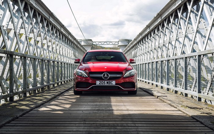 Red Mercedes Benz C63 AMG on a bridge