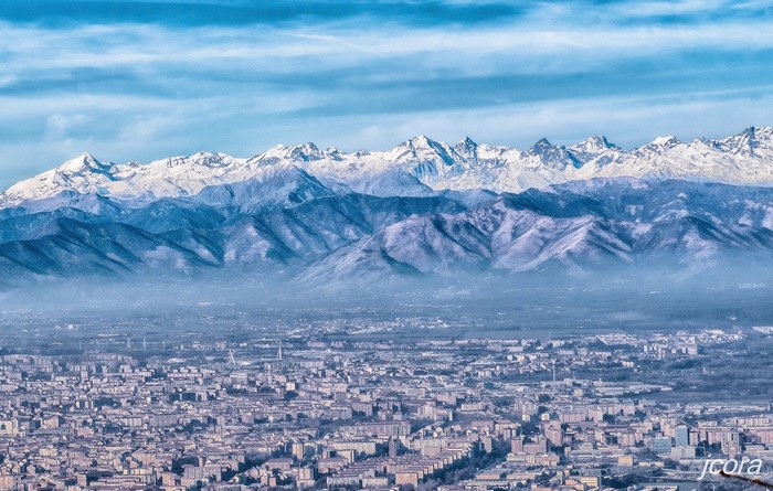 Cityscape with snowy mountain range in the background