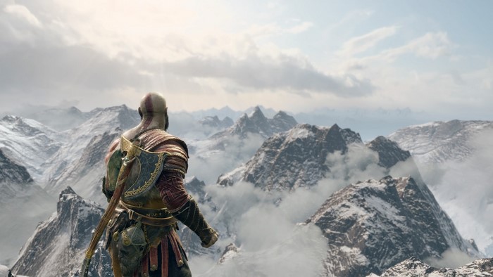 Kratos from God of War overlooking snowy mountains