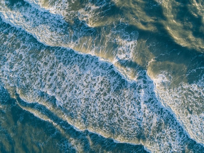 Aerial view of ocean waves crashing