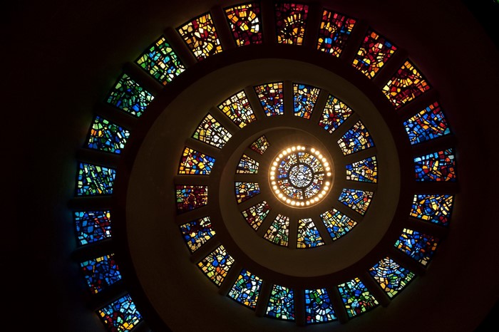 Spiral stained glass window with central light fixture