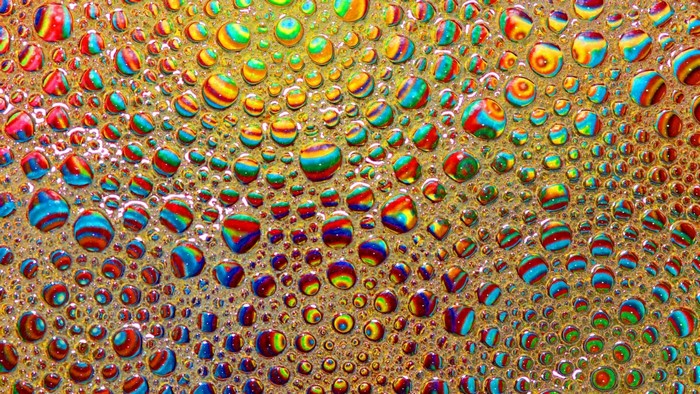 Colorful psychedelic bubbles on a golden surface